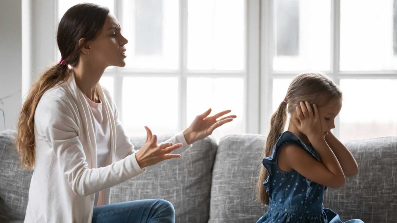 Stubborn small preschooler girl child close ears ignore loud young mother lecturing or scolding, mad Caucasian mom quarrel fight with little daughter, family misunderstanding, generation gap concept