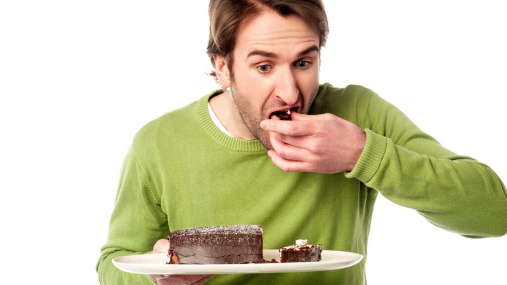 Man eating chocolate cake