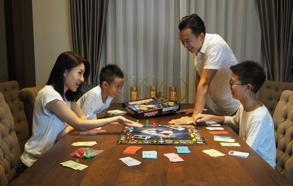 Family playing Monopoly game