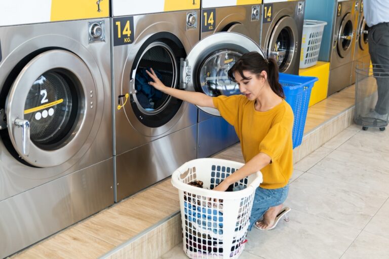 Woman using machine at Laundromat