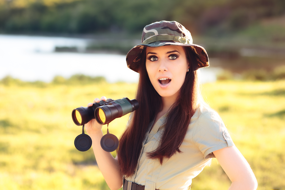 Pretty young woman with Binoculars