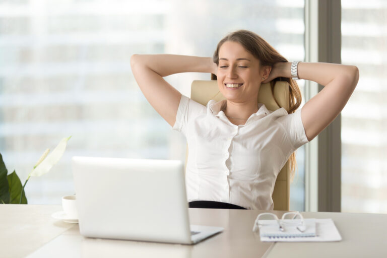 Happy Woman at Work Relaxed at Desk