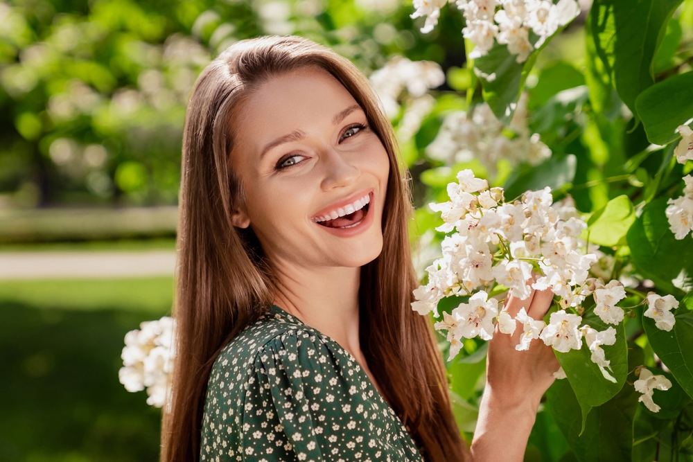 Happy woman smiling with flowers